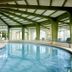 Das Alpenhaus Gasteinertal in Bad Hofgastein indoor pool with arched windows and loungers
