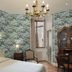 Hôtel de l'Abeille in Orléans: elegant room with floral wallpaper, chandelier, bed, desk and armoire