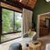 Ivory Tree Game Lodge, Pilanesberg: safari suite with large window, lounge chair and view to greenery