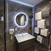 Achat Hotel Monschau bathroom with shower, illuminated round mirror, sink, and towel rack