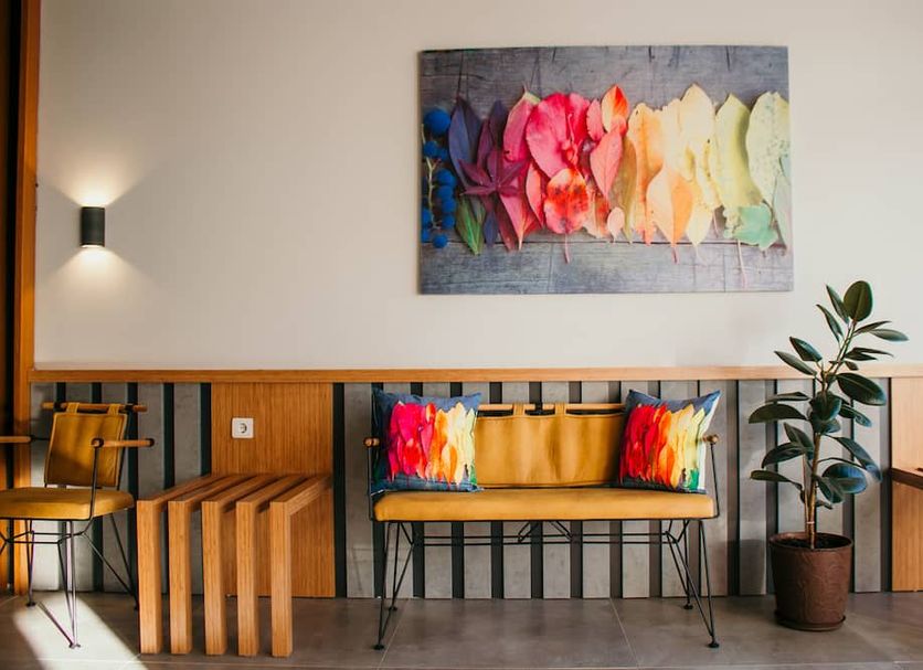 Hayat Palas in Erzincan lobby seating area with colorful wall art, wooden benches, and potted plant