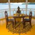Iris Island Eco Resort in Busuanga with a sea-view deck dining table and Buddha statue