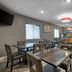 SureStay by Best Western Kansas City Country Inn North breakfast room with tables and buffet area