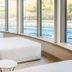 Heilthermen Resort Bad Waltersdorf lounge with chaise by panoramic windows overlooking pool