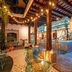 Adra Hostel in Antigua courtyard lounge with string lights, patterned floor, and colorful bar seating
