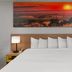 Days Inn by Wyndham Mason City guest room with king bed and sunset wall art