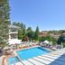 Clover Magic Altinkum Park Hotel in Side with outdoor pool, sun loungers, and palm-lined courtyard