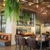 Kokotel Phuket Nai Yang Beach dining area in Phuket City with hanging plants and leather seating