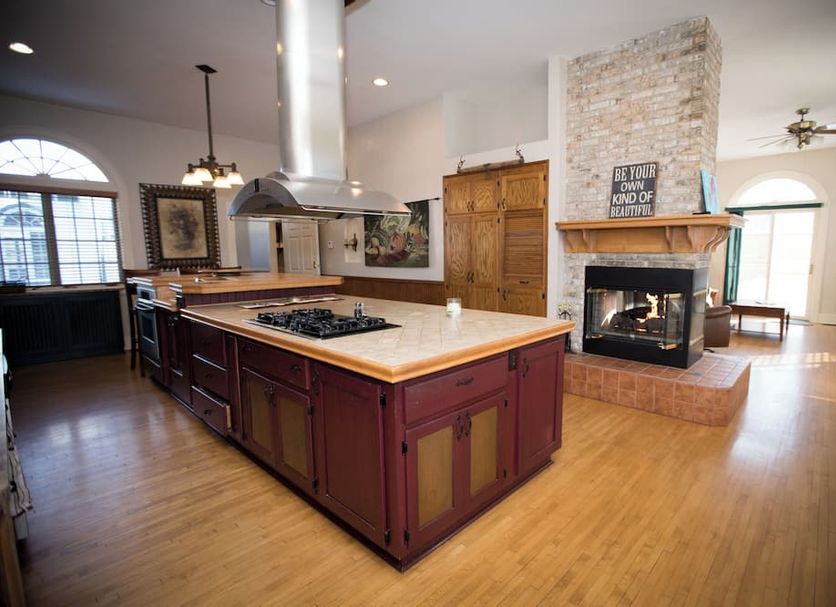 Victoria Resort And Bed & Breakfast in South Haven kitchen with island, fireplace, and hardwood floors