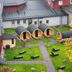 Ferien Appartements Am Berghotel Oberhof in Oberhof courtyard with barrel saunas, lawn, and autumn tree