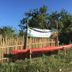 Palawan Sandcastles The Beach House in Busuanga with red kayaks beside a bamboo fence