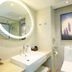 Lavande Hotels Nanjing Confucius Temple Daguang Road bathroom with round lit mirror and wall art