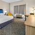 Hampton Inn & Suites Fort Worth/Forest Hill guest room with king bed, chair, desk and window