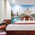 Hotel Taj Heritage, Agra: bed with Taj Mahal mural headboard and wood wardrobe in a guest room