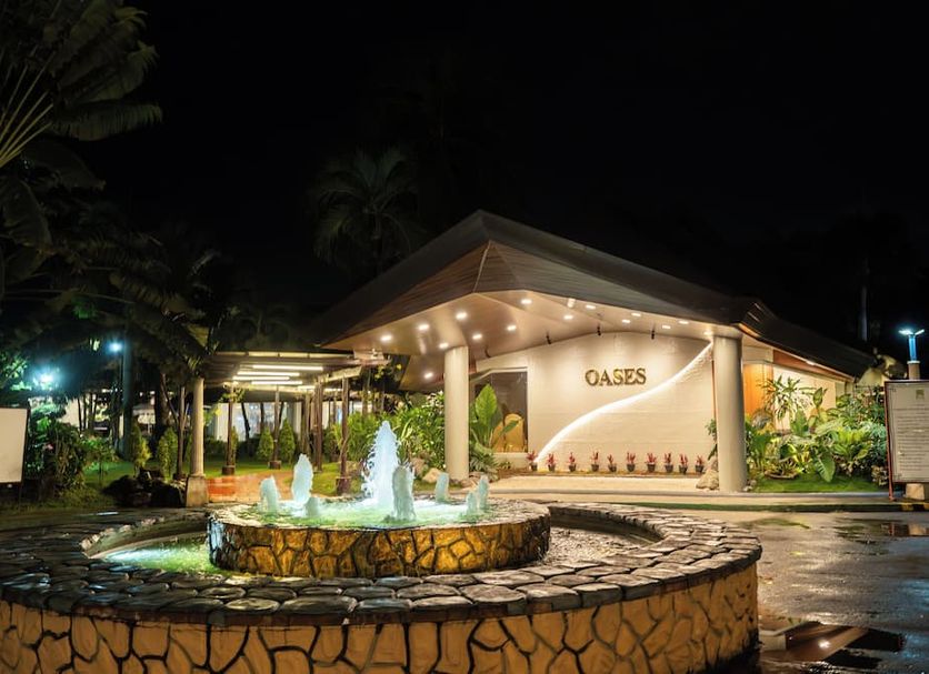 The Ritz Hotel at Garden Oases in Davao City with a lit entrance and fountain at night