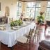 El Refugio Hotel & Spa in Sasaima dining room with set table and large windows