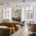 Rosewood Vienna in Vienna lounge with curved sofas, palm murals, and crystal chandeliers