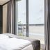 Downtown Apartments Mitte Berlin bedroom with large window and balcony view