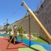 Gf Fañabe in Adeje: colorful playground with climbing frame and lawn beside hotel buildings