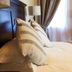 Old House Lodge, Beaufort West: bed with striped pillows beside a window and curtain in a guest room