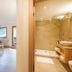 Familienhotel Mateera Gargellen room with bed, seating area, and ensuite bathroom in Montafon