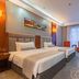 Yichang Guobin Bandao Hotel room in Yichang with two twin beds, desk, chairs, and large window
