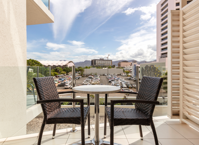 Park Regis City Quays Cairns balcony with two chairs, table and marina and mountain view