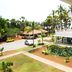 Nalla Eco Beach Resort in Pondicherry with tropical grounds, parked cars, and balcony view