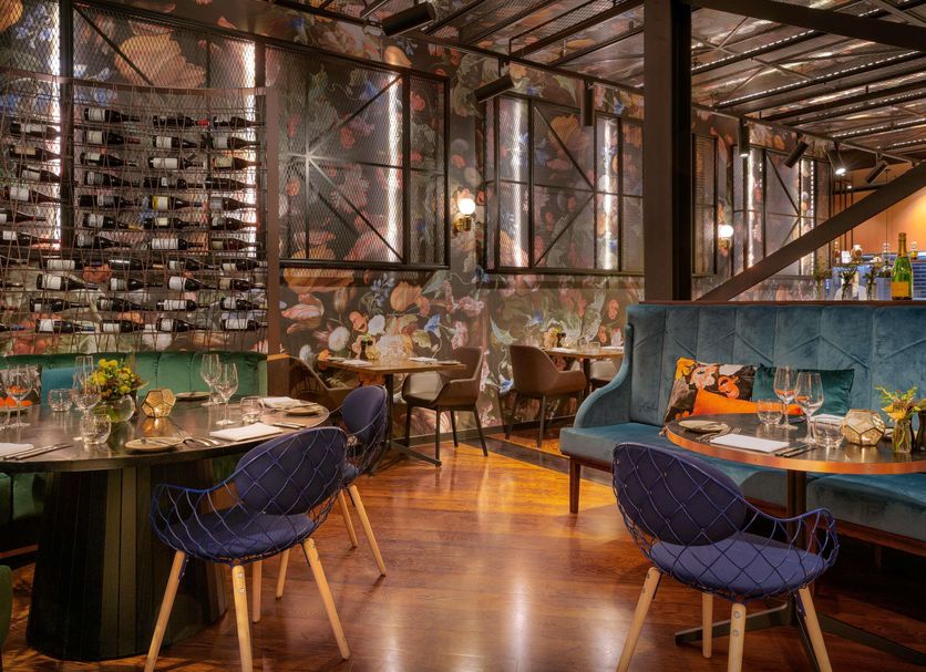 Sofitel Wellington restaurant with wine wall, plush seating and polished wood floors