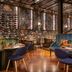 Sofitel Wellington restaurant with wine wall, plush seating and polished wood floors