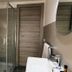 I Giardini della Castellana in Marina di Ragusa bathroom with glass shower, modern sink and wood door