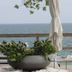 The Lakeside Prince Edward County patio with sea view, planter and umbrella by the water in Prince Edward