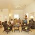 Casa 325 in Key West: airy guest lounge with wicker seating, twin beds, and ceiling fans