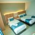 Alaxis Hotel Kuala Lumpur twin guest room with two beds, blue accents, wardrobe, and bedside lamp