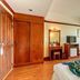 Chomsin Hua Hin room with wood wardrobe, twin beds, TV, desk, and balcony view in Hua Hin