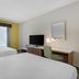 Best Western Wesley Chapel guest room with two beds, desk, TV, and window