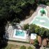 Hu I Pini village in Fiano Romano with aerial view of a lagoon-style pool and waterslide amid trees