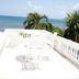 Bravo Beach Hotel in Vieques: white oceanfront terrace with chairs and sea view