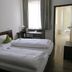 Bayerischer Hof in Münnerstadt guest room with twin beds, desk, and bathroom doorway