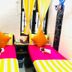 Woodstock Hostel Hong Kong twin room with bright pink beds and yellow striped bedding