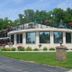 Amber's Inn & Suites in Wisconsin Dells with a curved exterior, rooftop patio, and landscaped lawn
