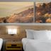 Days Inn by Wyndham Harrisonburg room with two beds and mountain landscape wall art