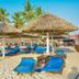 Best Western Jangwani Sea Breeze Hotel in Dar Es Salaam with sandy beach loungers and thatched umbrellas