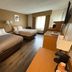 Quality Inn Perrysburg guest room with two beds, desk, and window light