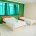 Hotel Dez De Julho in Manaus guest room with three single beds and green walls