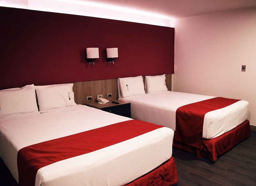 Hotel Ht Ole in Tijuana guest room with two double beds and red bedding
