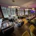 Hotel Am Schloss Ahrensburg restaurant with modern seating, set tables, and ring pendant lights