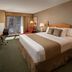 St. Eugene Golf Resort & Casino room in Cranbrook with king bed, desk, chairs, and balcony doors