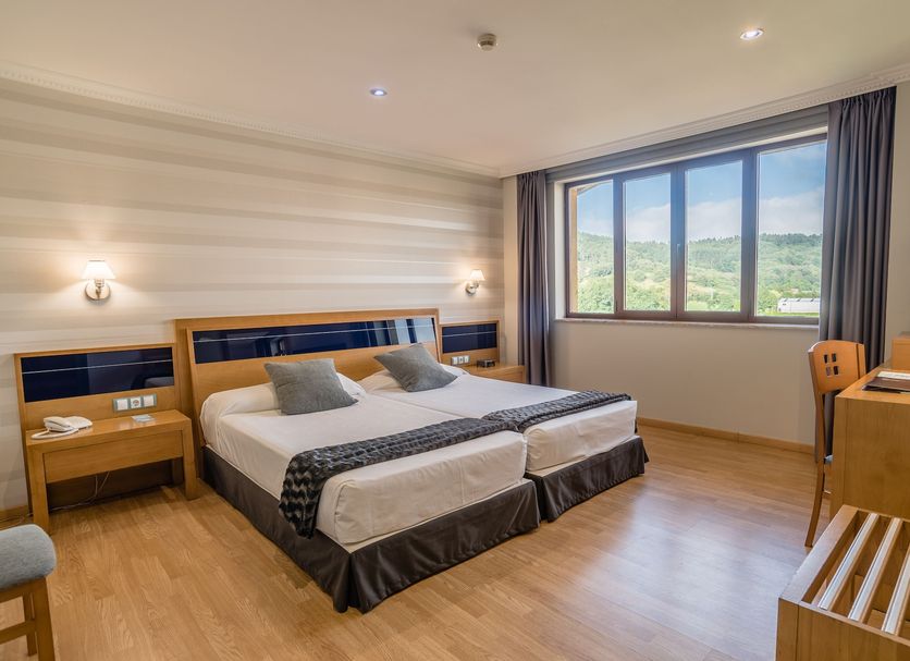 Hotel Spa Villa Pasiega in Hoznayo: twin bed room with large window and countryside view