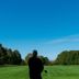 Maxwelton Braes Lodge in Baileys Harbor with a grassy lawn, trees, and a golf course view